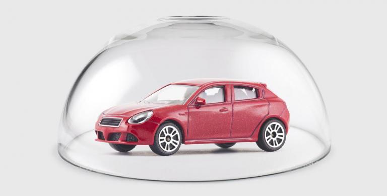 Red car protected under a glass dome